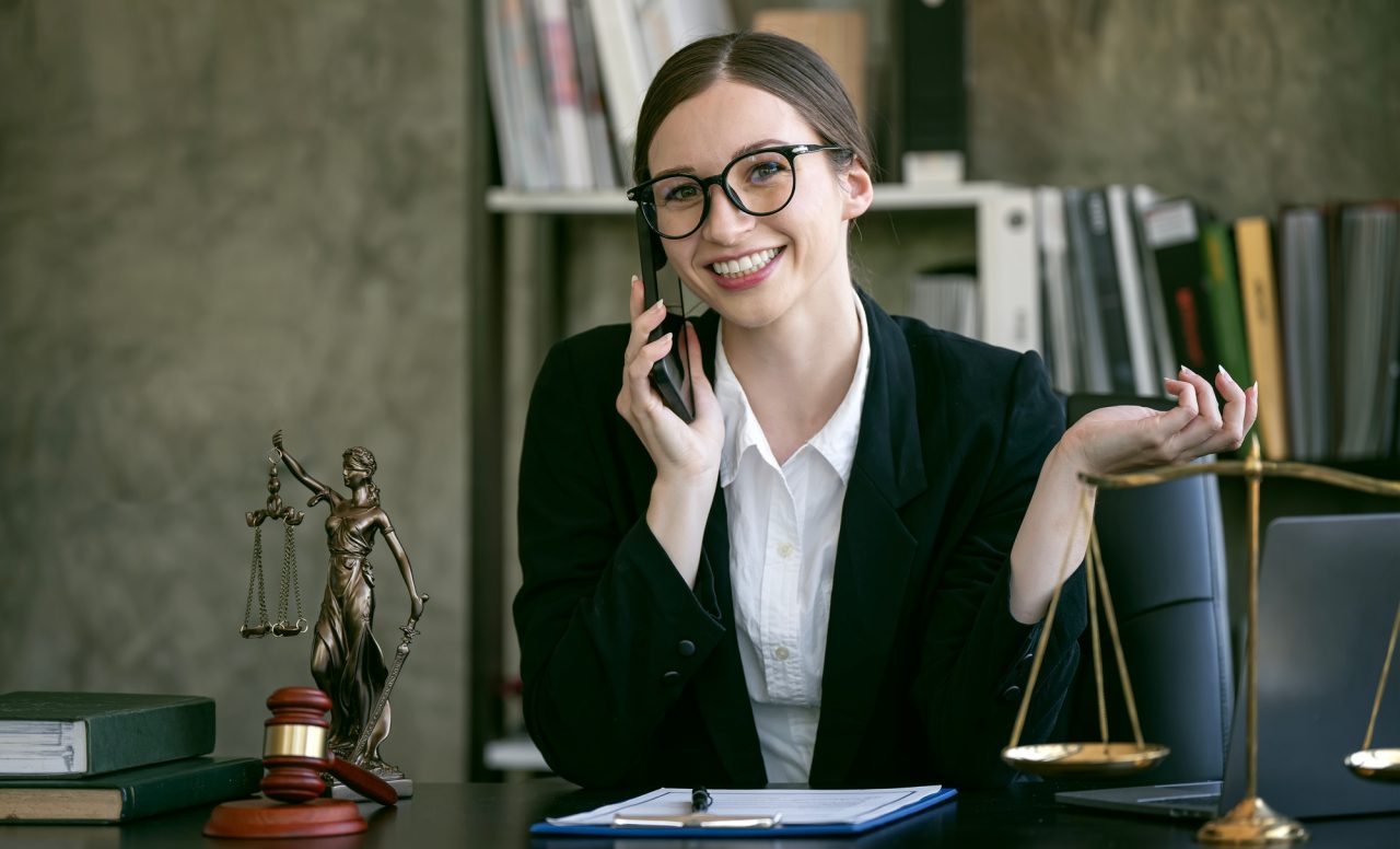 Portrait of young female lawyer or attorney working in the office smiling and looking at camera .jpg